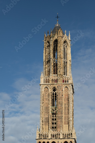 historic Dom Tower in Utrecht, tallest medieval belfry in the Netherlands, against a blue sky
