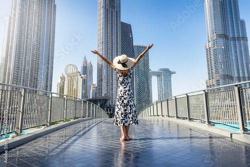 Photography A happy tourist woman in a white dress on a sightseeing trip through Downtown Du