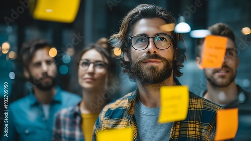 Man with glasses and beard actively participating in remote team brainstorming session with holograms