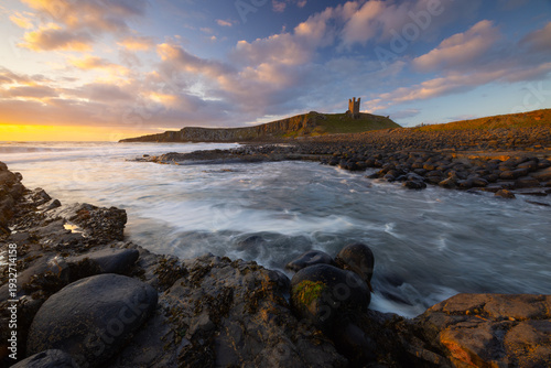Dunstanburgh Castle on a beautiful summer morning, Northumberland, England, UK.