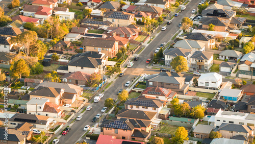 Aerial View of Australian Suburban Neighborhood with Solar Panel Rooftops at Golden Hour