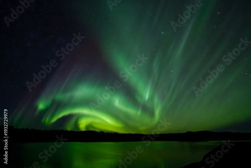 Vibrant Aurora Borealis Display Over Silhouetted Landscape