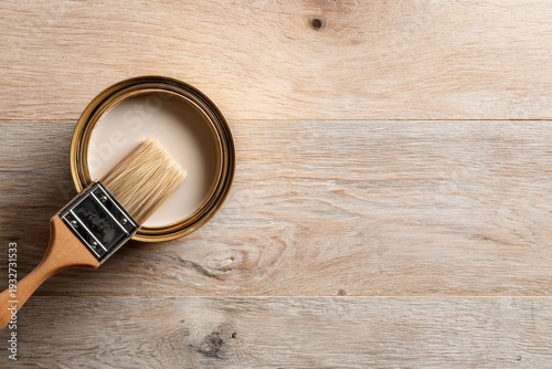 Paint Can and paintbrush on wooden background. Varnish on wood with paint brush. Timber furniture coating and protection. Banner, copy space. DIY project. Painting renovation repairing ad. Floor wax