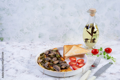 Omelette with mushrooms and green beans served with toast and cherry tomatoes