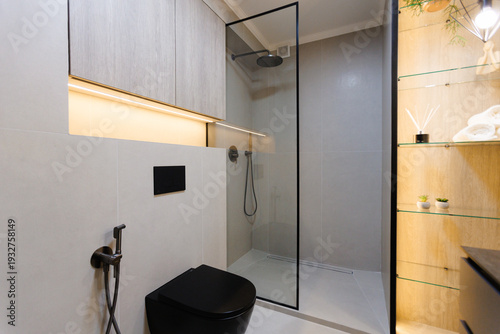 Contrast bathroom featuring black fixtures and glass shower