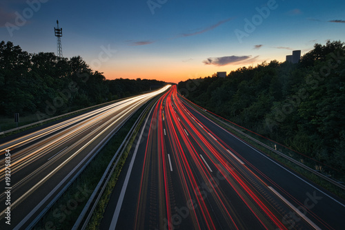 Long exposure of highway traffic at night on the A10 Berlin Ring near Dahlewitz, showing white and red car light trails and overhead road signs towards Dresden and Berlin-Tempelhof