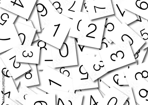 Scattered paper cards with black numbers and numerals representing mathematics