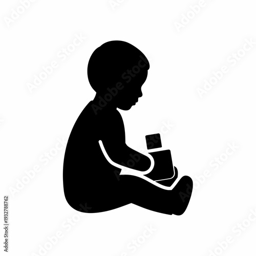 Silhouette of a baby holding bottle.