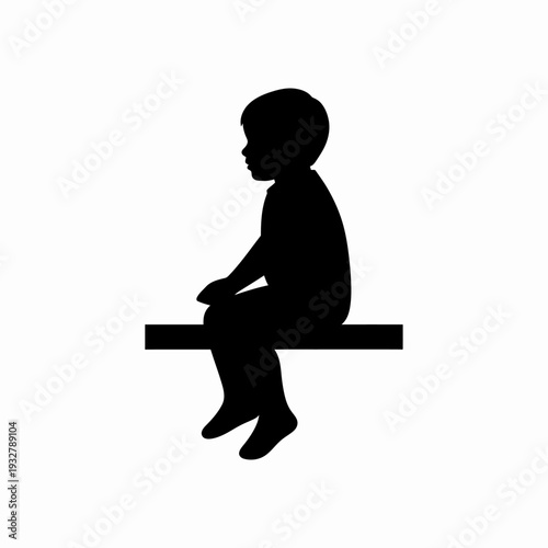 Silhouette of a Young Boy Sitting Alone.
