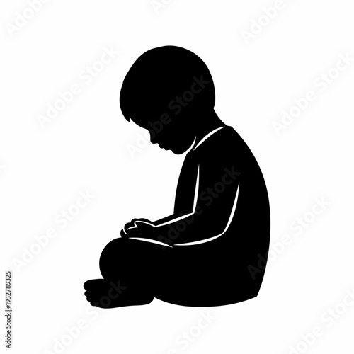 Silhouette of a Sitting Young Child.