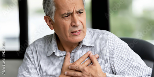 Senior man suffering from a sudden heart attack, collapsing with acute chest pain, needing urgent medical attention