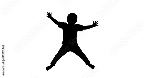 Silhouette of a jumping young boy.