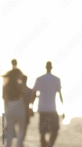 Wallpaper Mural Blurred silhouettes of young people walking on the quay in bright white light Torontodigital.ca