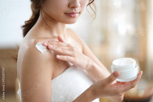 Woman Applying Moisturizer with Towel on Shoulders, Skincare Routine