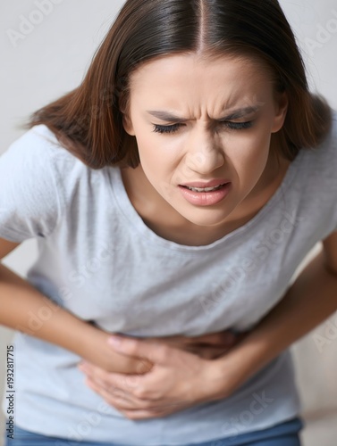 Woman Gripping Stomach in Pain - Portrait