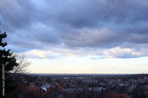 Evening Panoramic View of a City with Dramatic Cloudy Sky