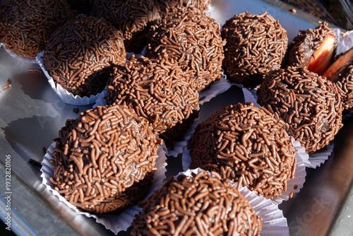 High-angle close-up of delicious Brazilian chocolate brigaderios. Rich truffles covered in crunchy sprinkles. 