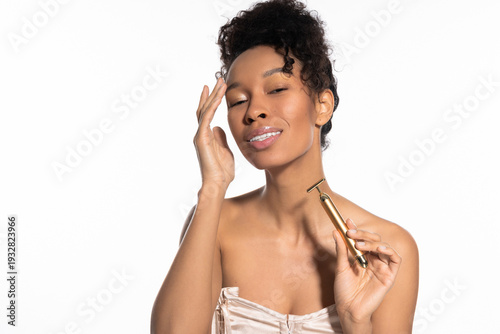 Photography Beautiful young woman enjoys a moment of self care while using a stylish groomin