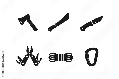 Collection of survival and camping tools including an axe, machete, knife, multi-tool, rope, and carabiner