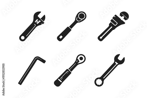 Collection of various hand tools including wrenches and ratchets on a white background
