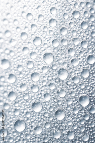 Close-up of water droplets on a metallic surface texture