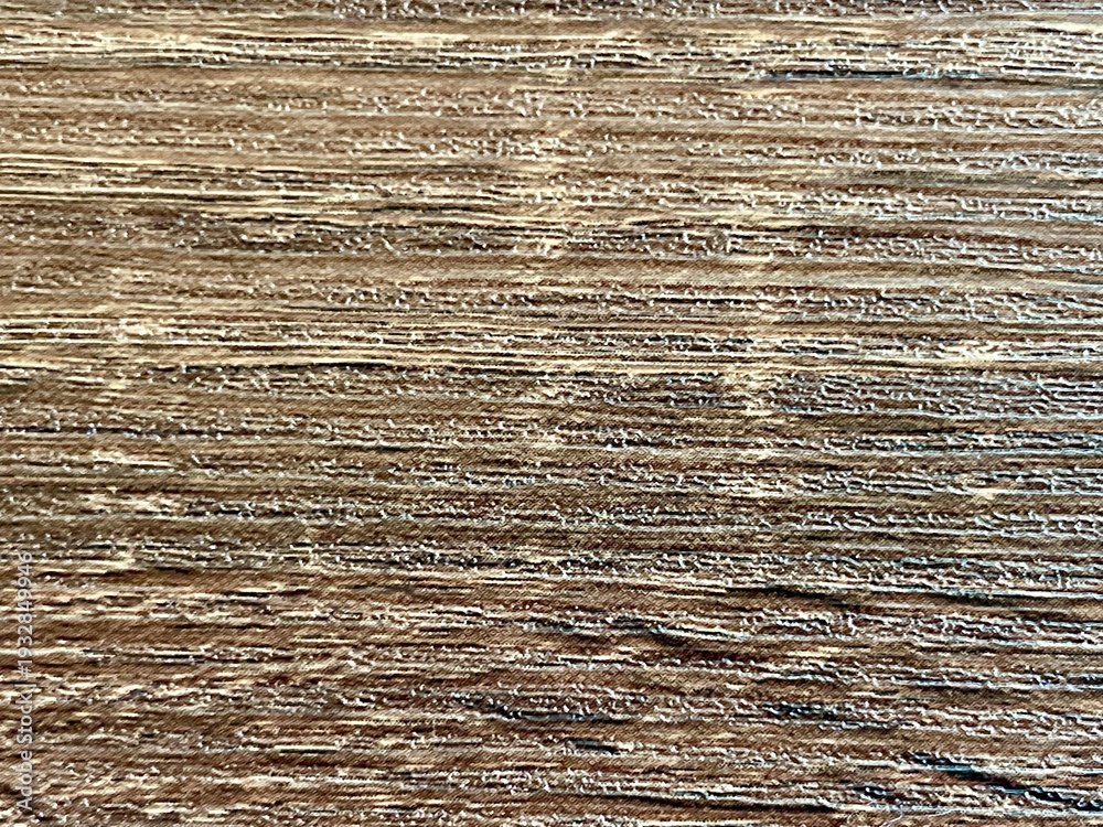 Fototapeta premium Close-up of a rustic weathered wood surface with a detailed grain and natural brown texture.