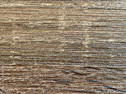 Close-up of a rustic weathered wood surface with a detailed grain and natural brown texture.
