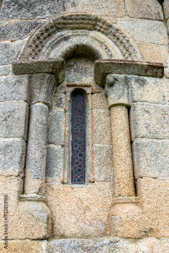 Time-honored 12th-century Romanesque window of the San Martiño de Agudelo church apse with granite columns and semicircular arch, Barro, Pontevedra, Spain
