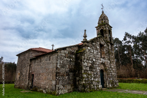 Robust 12th-century Romanesque parish church of San Martiño de Agudelo with a Baroque stone belfry and granite masonry, Barro, Pontevedra, Spain