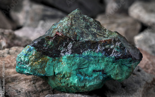 Slika na platnu Copper (Cu) ore in foreground, textured rock background