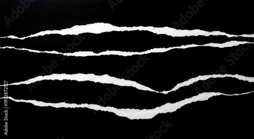Torn paper edge strips isolated on black background for design element usage in graphic projects