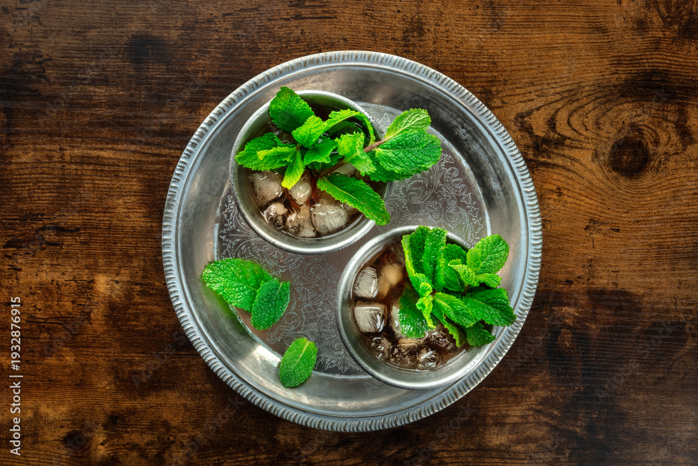 Fototapeta premium Mint Julep in the Kentucky Derby classic silver glass, with fresh mint leaves