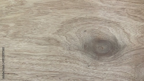 A natural wood texture with a fine grain pattern and prominent knots in the center. Suitable for use as a backdrop for natural, rustic, interior, and minimalist designs.