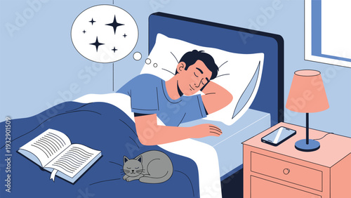 Young man sleeping soundly in his bed with a small cat curled up on the blanket and a nightstand nearby.