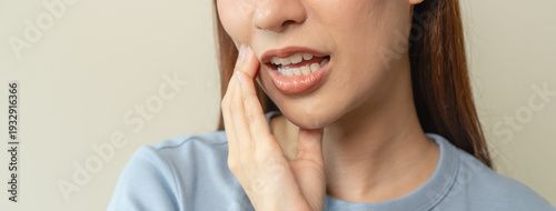 Fotografi Face expression suffering from sensitive teeth, Asian young woman touching cheek