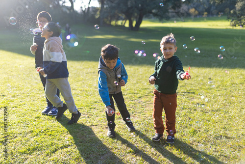Childhood joy, boys blowing soap bubbles outdoors