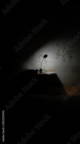 Conceptual Dark Interior with Desk Lamp Symbolizing Solitude and Productivity