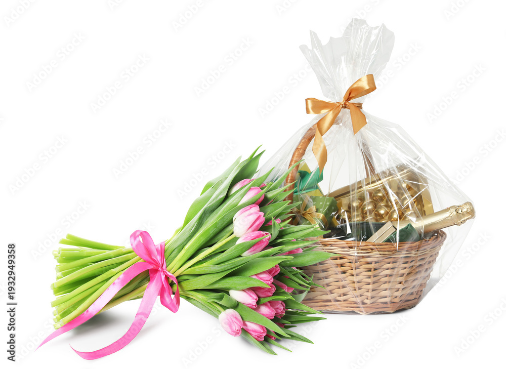 Fototapeta premium Festive basket with wine, gift boxes, candies and bouquet of flowers on white background