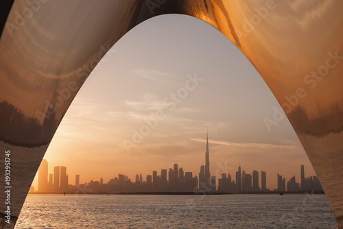 Tableau sur toile Spot to enjoy the Dubai city skyline at sunset, contemporary urban design, architecture, and a tranquil waterway, view from Creek Harbor