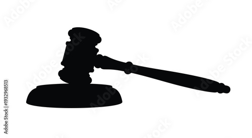 A stark black silhouette of a gavel resting on a sound block representing justice and legal decisions silhouette