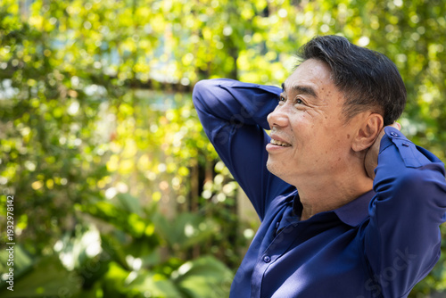 Quadro su tela Relaxed happy carefree middle age old Asian man breathing the clean, unpolluted