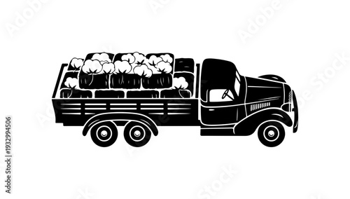 Vintage truck loaded with hay bales on rural road