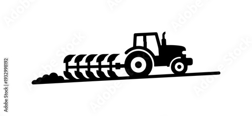 Tractor cultivating soil with agricultural equipment