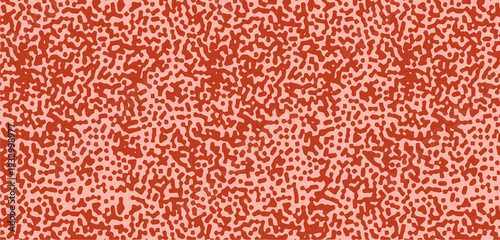 Seamless pattern with abstract orange and red speckled sponge texture