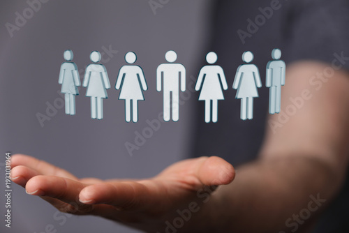 Hand holding human figures....