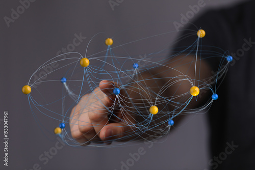 Hand holding a 3D network m...