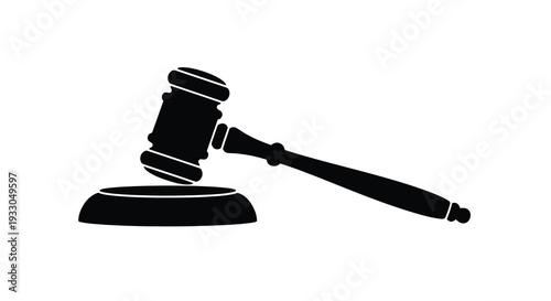 A stark black silhouette of a gavel resting on a sound block symbolizes justice and legal proceedings silhouette