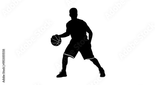 Silhouette of a basketball player in action with the ball