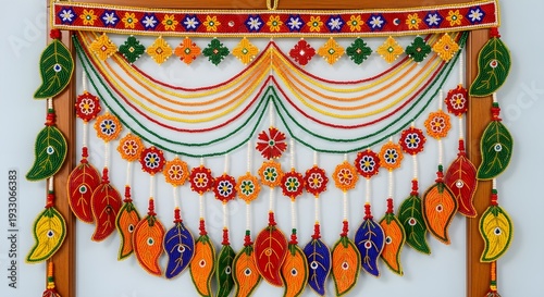 Vibrant Indian-style door decoration with colorful leaves and flowers hanging on a wall