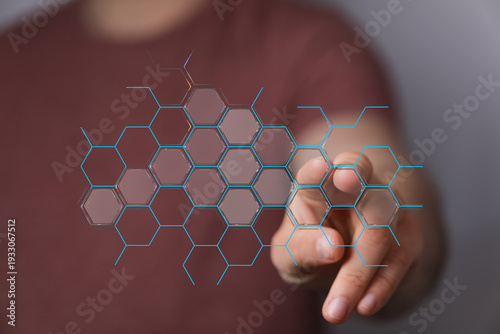 Abstract concept of digital technology. Hand interacting with a digital hexagon interface, representing connection and i